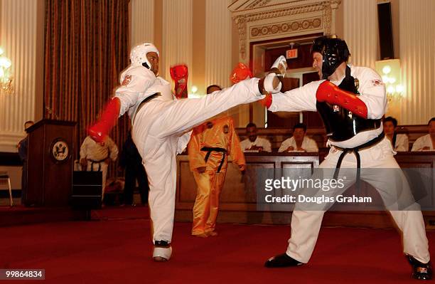 Jesse Jackson, Jr., D-Ill., and Bob Schaffer, R-Colo., spar during there black belt test in the Cannon Caucus room.
