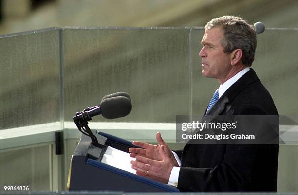 After being sworn in as the 43rd President of the United States George W. Bush hugs addresses the crowd on the West Front of the U.S. Capitol.