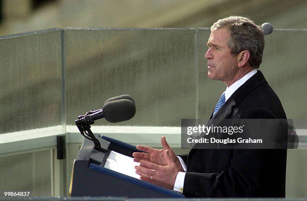 After being sworn in as the 43rd President of the United States George W. Bush hugs addresses the crowd on the West Front of the U.S. Capitol.