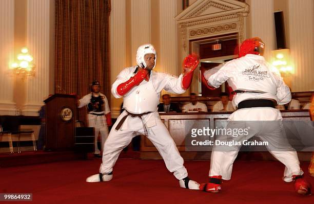 Jesse Jackson, Jr., D-Ill., and Nick Smith, R-Mich., spar during there black belt test in the Cannon Caucus room.