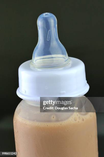 chocolate milk in a infant feeding bottle - chocolate milk bottle stock pictures, royalty-free photos & images