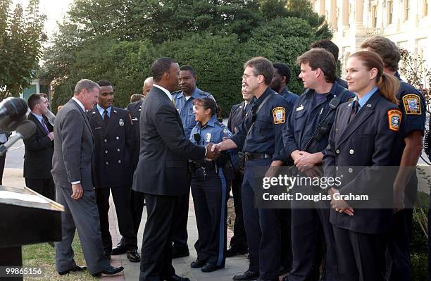 Watts, R-Okla., greets firefighters before a press conference on the resolution recognizing the sacrifice and courage of the first responders at the...