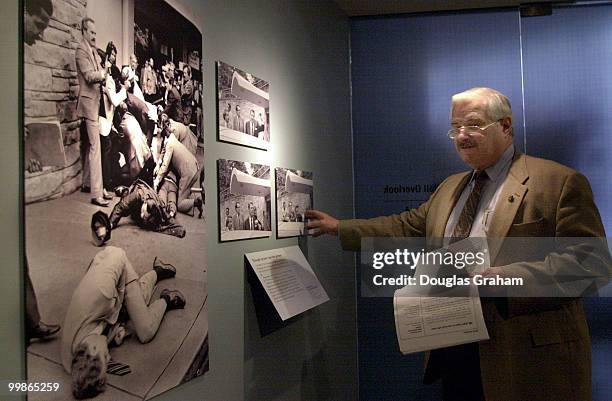 United States Capitol Police chief James J. Varey inspects Pulitzer Prize winning photos taken by Ron Edmonds of the Associated Press at the Newseum...