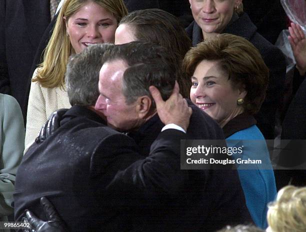 President George W. Bush hugs his Dad Former President George Bush Senior during the 43rd Inauguration on the West Front of the U.S. Capitol.