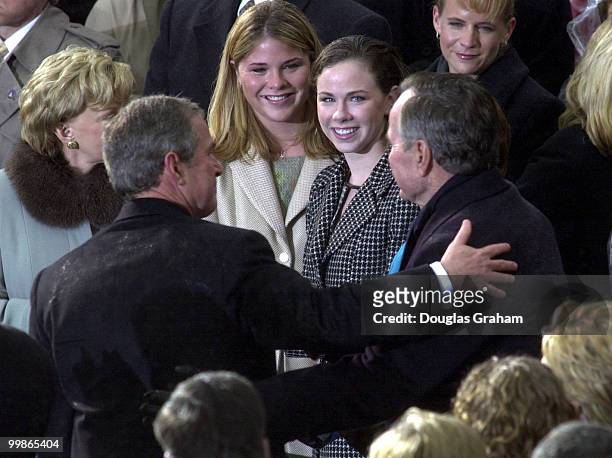 President George W. Bush hugs his Dad Former President George Bush Senior during the 43rd Inauguration on the West Front of the U.S. Capitol.