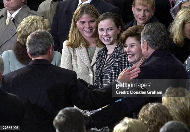 President George W. Bush hugs his Dad Former President George Bush Senior during the 43rd Inauguration on the West Front of the U.S. Capitol.