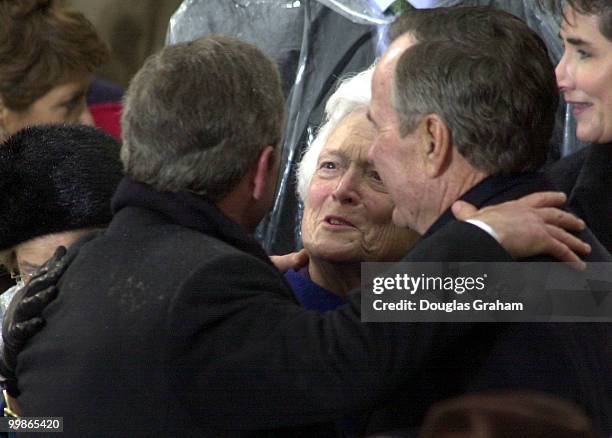 President George W. Bush hugs his Dad Former President George Bush Senior during the 43rd Inauguration on the West Front of the U.S. Capitol.
