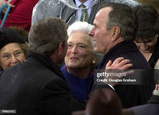 President George W. Bush hugs his Dad Former President George Bush Senior during the 43rd Inauguration on the West Front of the U.S. Capitol.