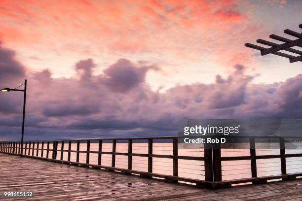woody point jetty at sunset - sunset point stock pictures, royalty-free photos & images