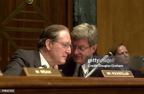 Senate Finance Committee chairman Max Baucus, D-Mont., and John D. Rockefeller, D-W.Va., talk during the hearing on trade promotion authority.