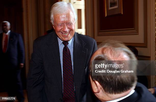 President Jimmy Carter greets Max Cleland, D-GA., during a meeting with members of Congress to urge normalizing relations with Cuba.
