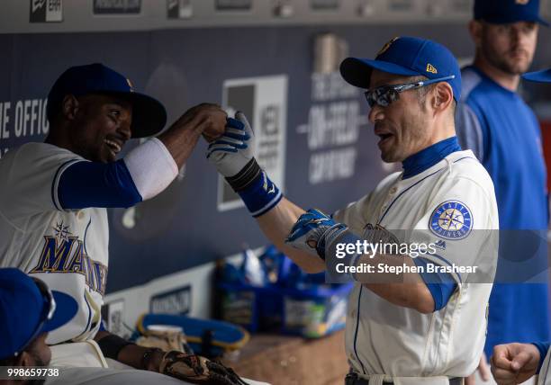 Ichiro Suzuki, right, of the Seattle Mariners jokes with Dee Gordon of the Seattle Mariners in the dugout before a game against the Colorado Rockies...