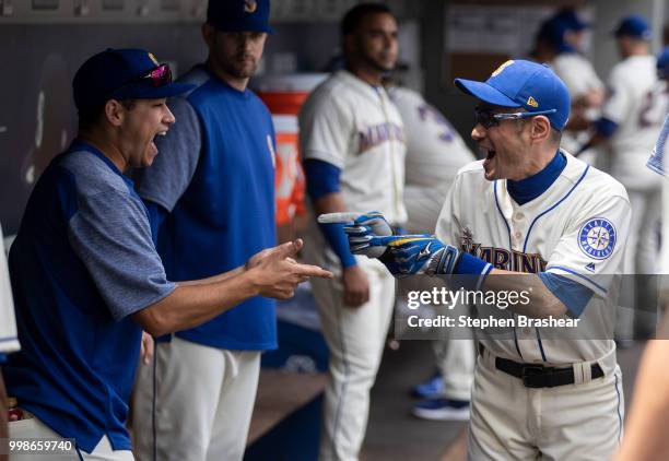 Ichiro Suzuki of the Seattle Mariners jokes with Marco Gonzales of the Seattle Mariners before a game against the Colorado Rockies at Safeco Field on...