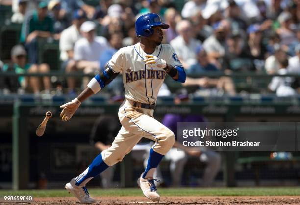 Dee Gordon of the Seattle Mariners runs to first base after putting the ball in play during an at-bat in a game against the Colorado Rockies at...