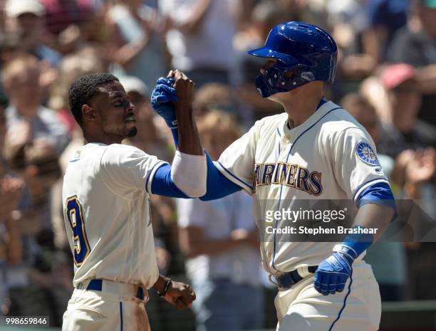Ryon Healy of the Seattle Mariners is congratulated by Dee Gordon of the Seattle Mariners after hitting a home run during a game against the Colorado...