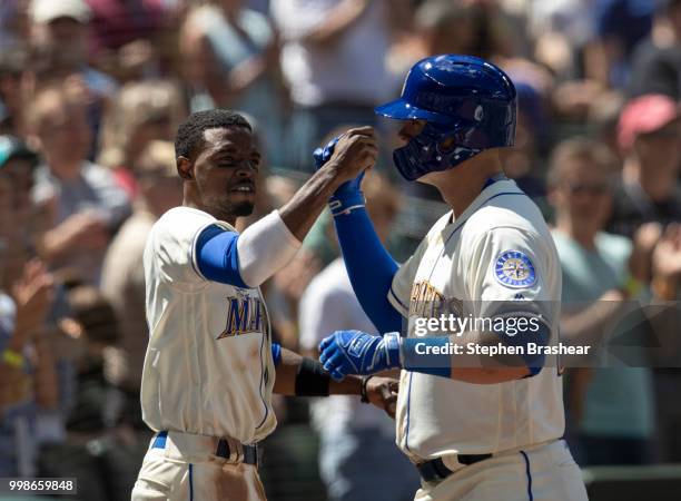 Ryon Healy of the Seattle Mariners is congratulated by Dee Gordon of the Seattle Mariners after hitting a home run during a game against the Colorado...