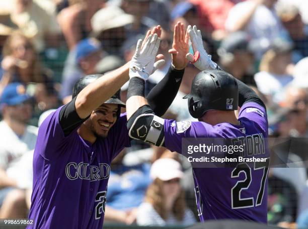 Trevor Story of the Colorado Rockies is congratulated by Nolan Arenado of the Colorado Rockies after hitting a home run during a game against the...