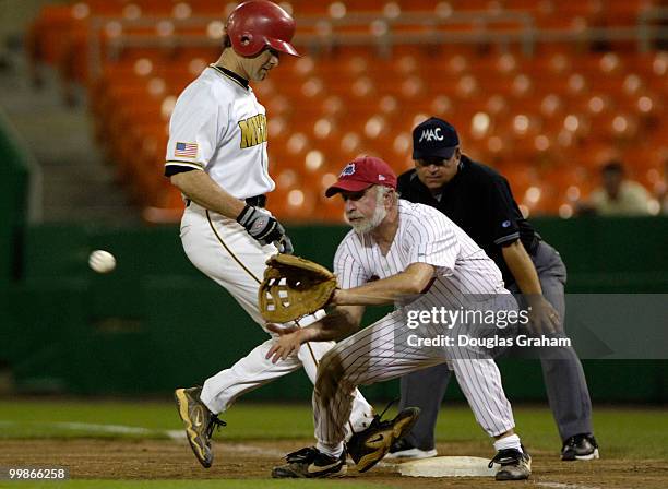 Graham Barrett is almost picked off at 1st as Tim Bishop waits for the ball during the 45th Annual Roll Call Congressional Baseball Game at RFK...