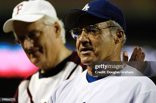 Joe Baca gets a pat on the back from Bill Pascrell after retiring from the 45th Annual Roll Call Congressional Baseball Game at RFK Stadium in...