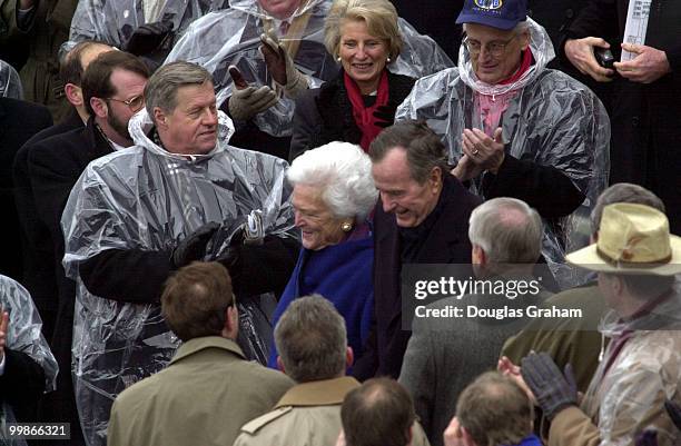 Members of Congress greet President George Bush and his wife Barbara in the poring rain as they wait for George W. Bush to be sworn in as the 43rd...