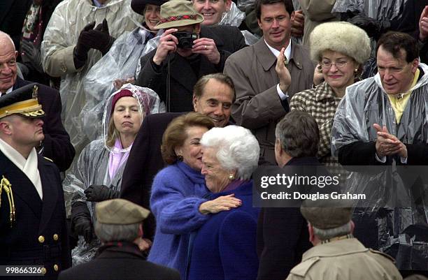 Bob Dole and his wife Elizabeth greet President George Bush and his wife Barbara in the poring rain as they wait for George W. Bush to be sworn in as...