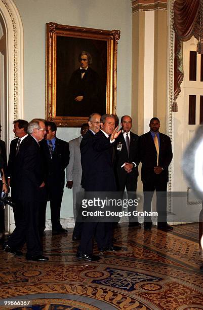 Presdent George W. Bush and Larry E. Craig, R-Idaho, walk to the Senate luncheon.