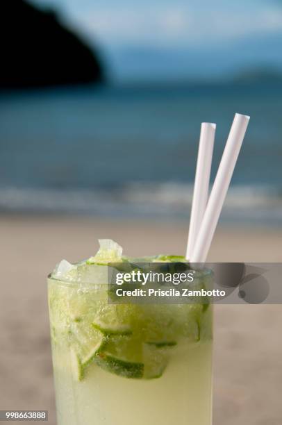 glass of caipirinha on the beach. paraty, rj, brazil - caipirinha foto e immagini stock