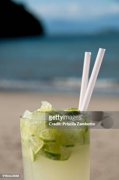 glass of caipirinha on the beach. paraty, rj, brazil - caipirinha stock pictures, royalty-free photos & images
