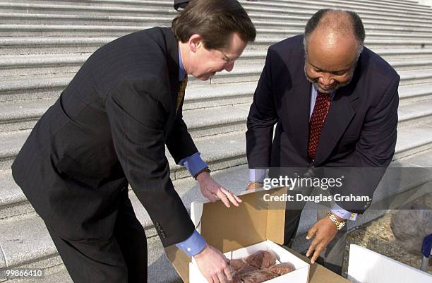 Earl Pomeroy, D-N. D., and Bennie G. Thompson, D-Miss. Pose on the East Capitol steps after a bet over the NCAA semi-finials, North Dakota State vs....