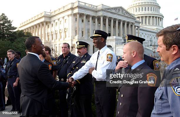 Watts, R-Okla., greets firefighters before a press conference on the resolution recognizing the sacrifice and courage of the first responders at the...