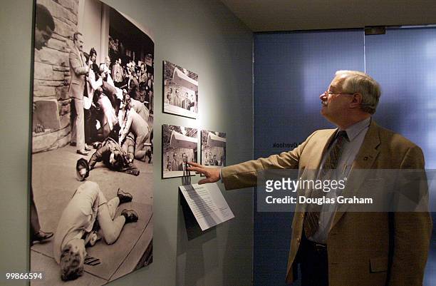 United States Capitol Police chief James J. Varey inspects Pulitzer Prize winning photos taken by Ron Edmonds of the Associated Press at the Newseum...