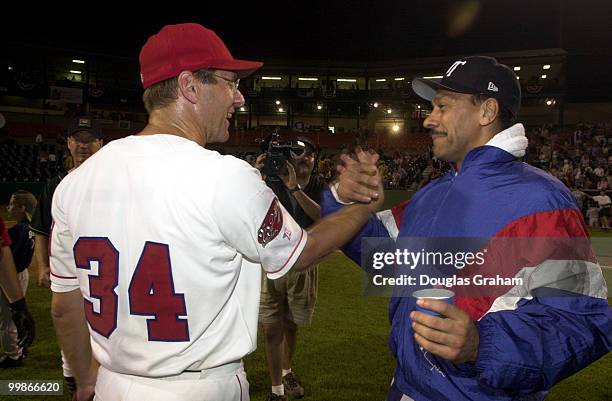 Steve Largent, R-OK., and Melvin Watt, D-N.C., congratulate each other after the 40th Annual Roll Call Congressional Baseball Game.