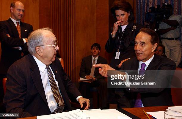 Jesse Helms, R-N.C.,talks with former senator Bob Dole before the start of the confirmation hearing of Daniel Coats to be ambassador to the Federal...