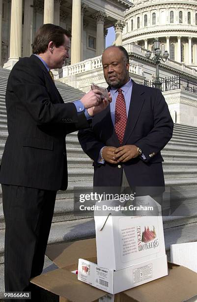 Earl Pomeroy, D-N. D., and Bennie G. Thompson, D-Miss. Pose on the East Capitol steps after a bet over the NCAA semi-finials, North Dakota State vs....