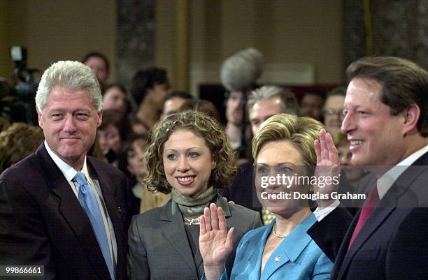 President Bill Clinton and Chelsea look on as Freashmen Senator Hillary Clinton is sworn in by Vice President Al Gore in the old Senate Chamber.