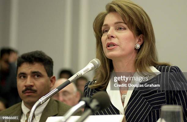 Jesus Martinez a lindmine survivor, listens to Queen Noor of Jordan as she testifies before the House Human Rights Caucus Hearing on an appeal for...