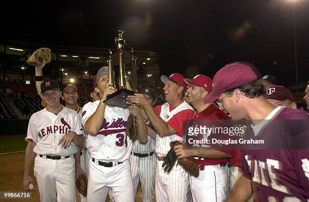 Steve Largent, R-OK., kisses the trophy after the Republicans won the 40th Annual Roll Call Congressional Baseball Game.