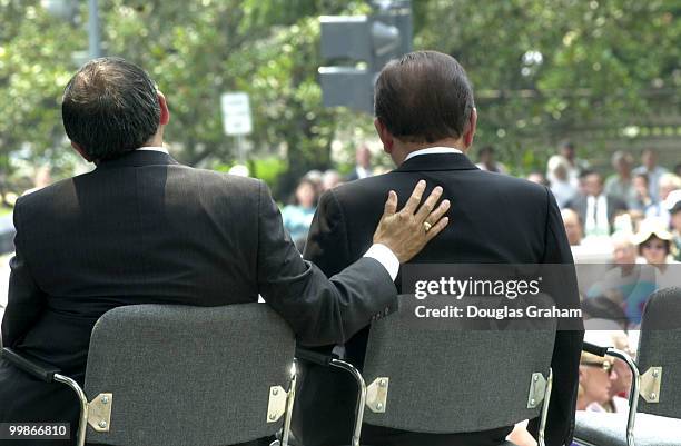 Norman Mineta pats Daniel K. Inouye, D-HI., on the back after Inouye gave an emotional speech during the Japanese American World WarII Memorial...