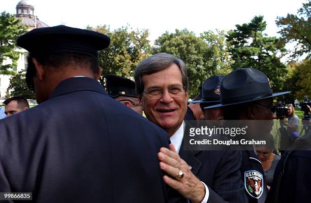 Trent Lott, R-Miss., talks with firemen and policemen after the"Day of Remembrance" ceremony at the U.S. Capitol. The ceremony was to honor the...