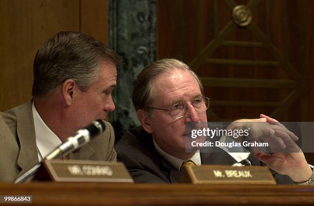 John Breaux, D-La., and John D. Rockefeller, D-W.Va., talk during the Senate Finance Committee hearing on trade promotion authority.