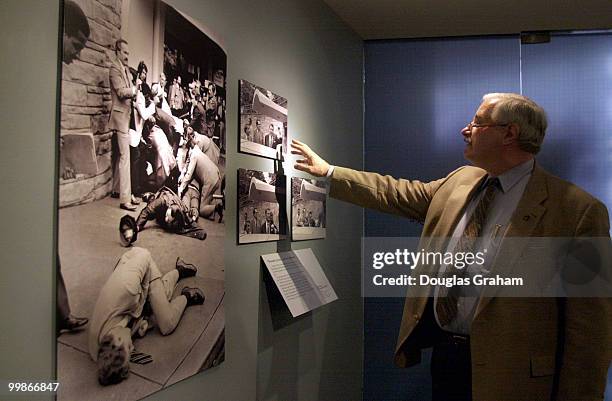 United States Capitol Police chief James J. Varey inspects Pulitzer Prize winning photos taken by Ron Edmonds of the Associated Press at the Newseum...