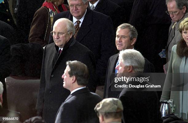 Dick Cheney and George W. Bush wait to be sworn in as Vice President and President as Vice President Al Gore and President Bill Clinton look on...