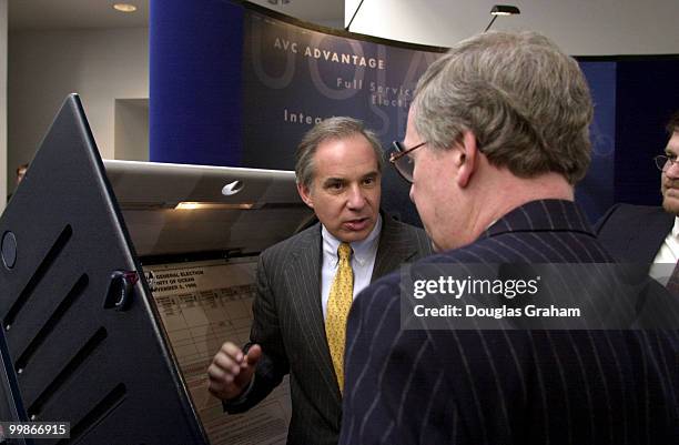 Mitch McConnell, R-Ky. And Robert G. Torricelli, D-N.J., check out a new voting machine before the start of there press conference on the election...