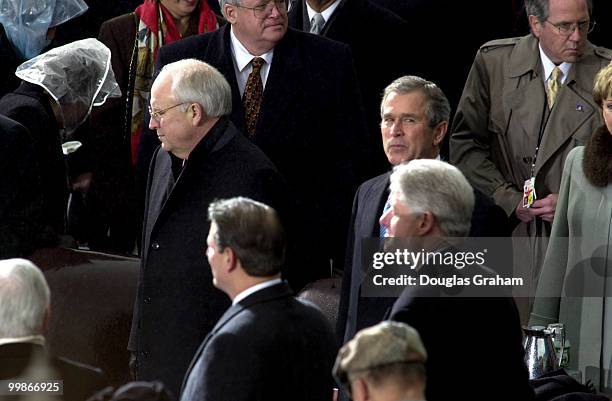 Dick Cheney and George W. Bush wait to be sworn in as Vice President and President as Vice President Al Gore and President Bill Clinton look on...