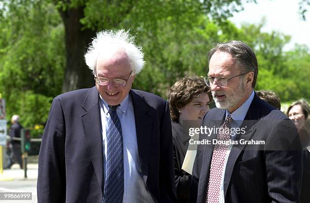 Bernard Sanders, I-Vt., and David Bonior, D-Mich., talk before the start of a press conference on China and human rights.