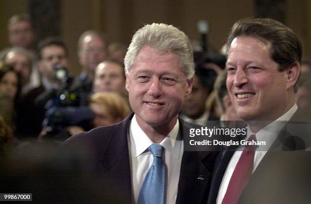 President Bill Clinton and Vice President Al Gore share a moment as Freashmen Senator Hillary Clinton is sworn in.