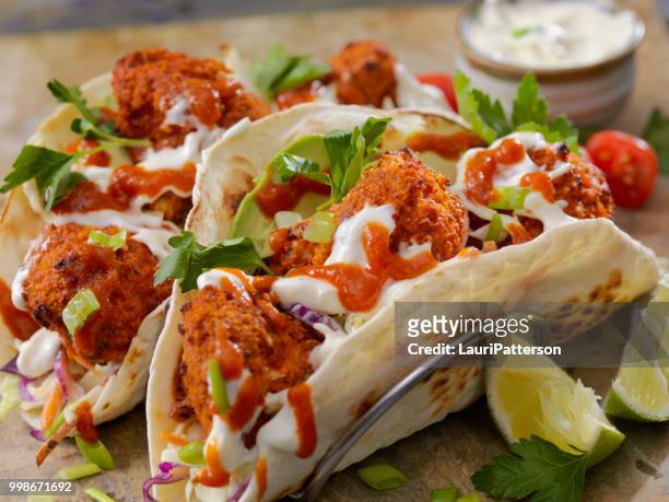 crispy baked buffalo wing cauliflower tacos - buffalo chicken wings stock pictures, royalty-free photos & images