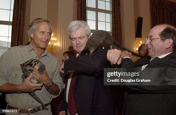 Jack Hanna holding a Clouded Leopard, looks on as Former Speaker of the House Newt Gingrich, R-Ga., as Wayne T. Gilchrest, R-Md., have their hands...