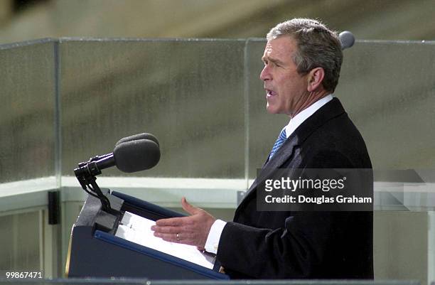 After being sworn in as the 43rd President of the United States George W. Bush hugs addresses the crowd on the West Front of the U.S. Capitol.