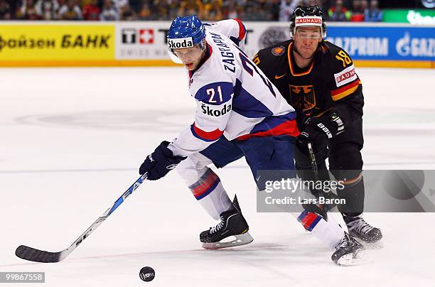 Marek Zagrapan of Slovakia is challenged by Kai Hospelt of Germany during the IIHF World Championship qualification round match between Slovakia and...